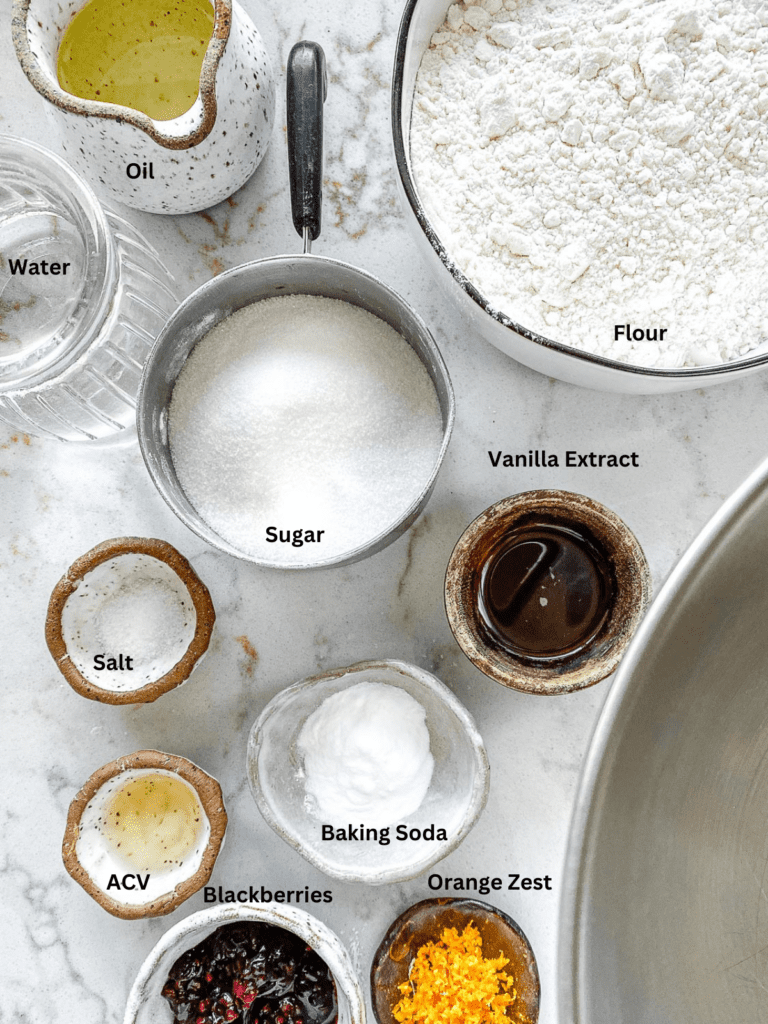 Ingredients for Blackberry Orange cupcakes measured out on a white surface.
