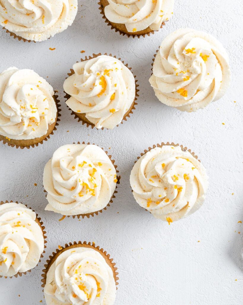 Completed Blackberry Orange Cupcakes displayed on a white surface.