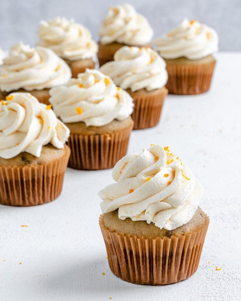 Completed Blackberry Orange Cupcakes displayed on a white surface.