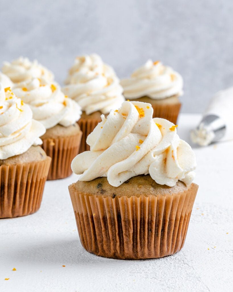 Completed Blackberry Orange Cupcakes displayed on a white surface.