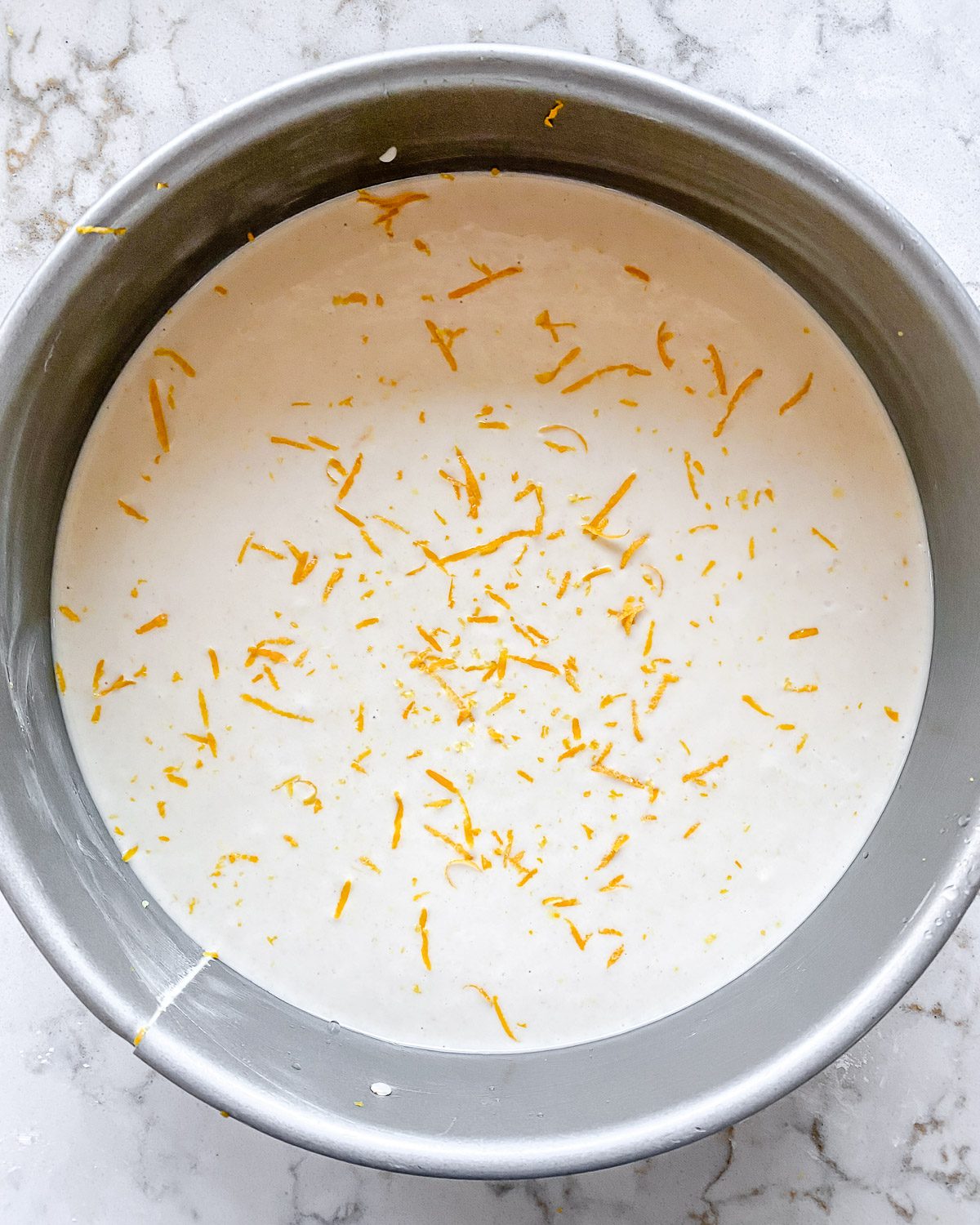 process of post pouring Lemon Frosting Cake batter into baking pan
