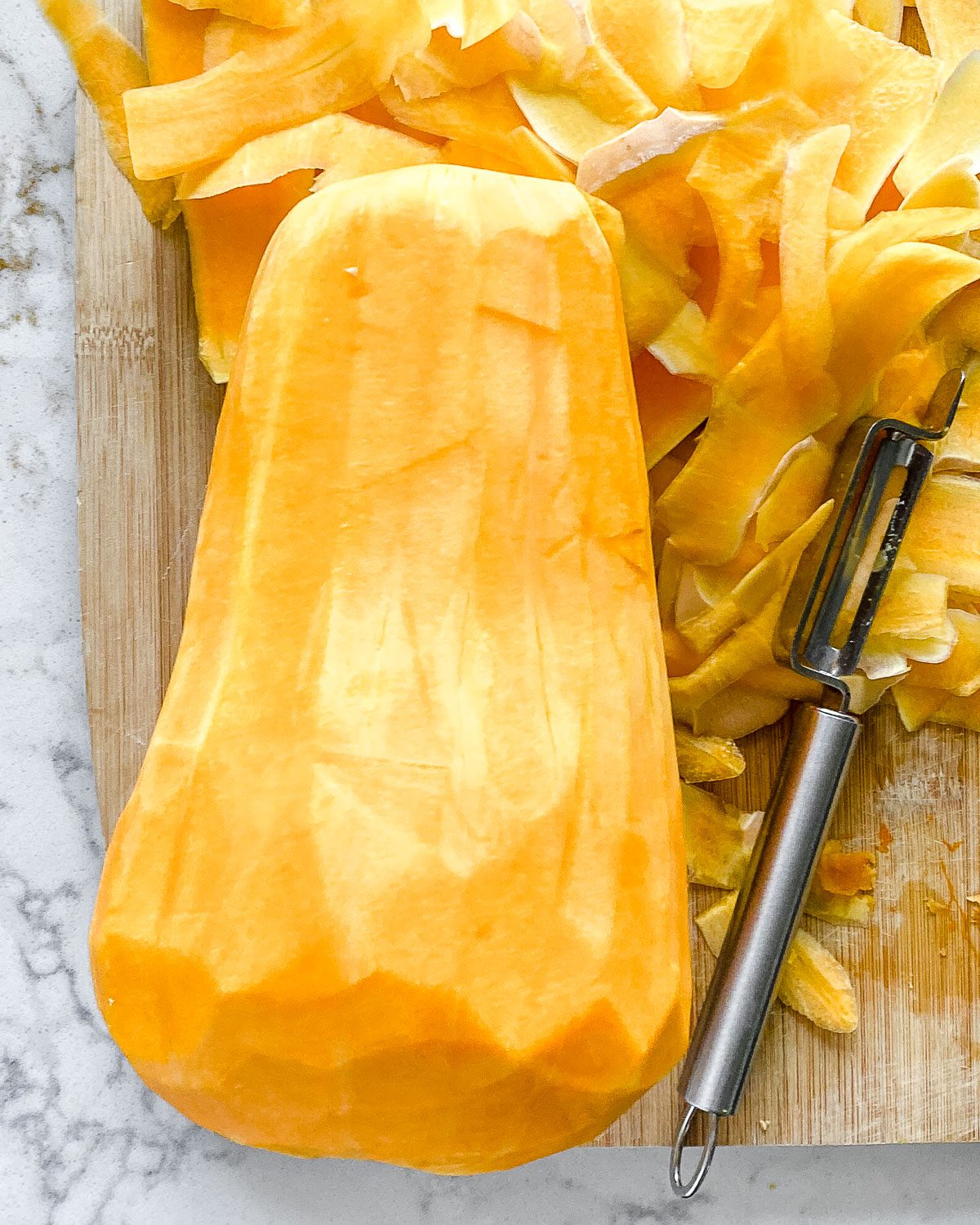Process showing post taking off the skin of a butternut squash.