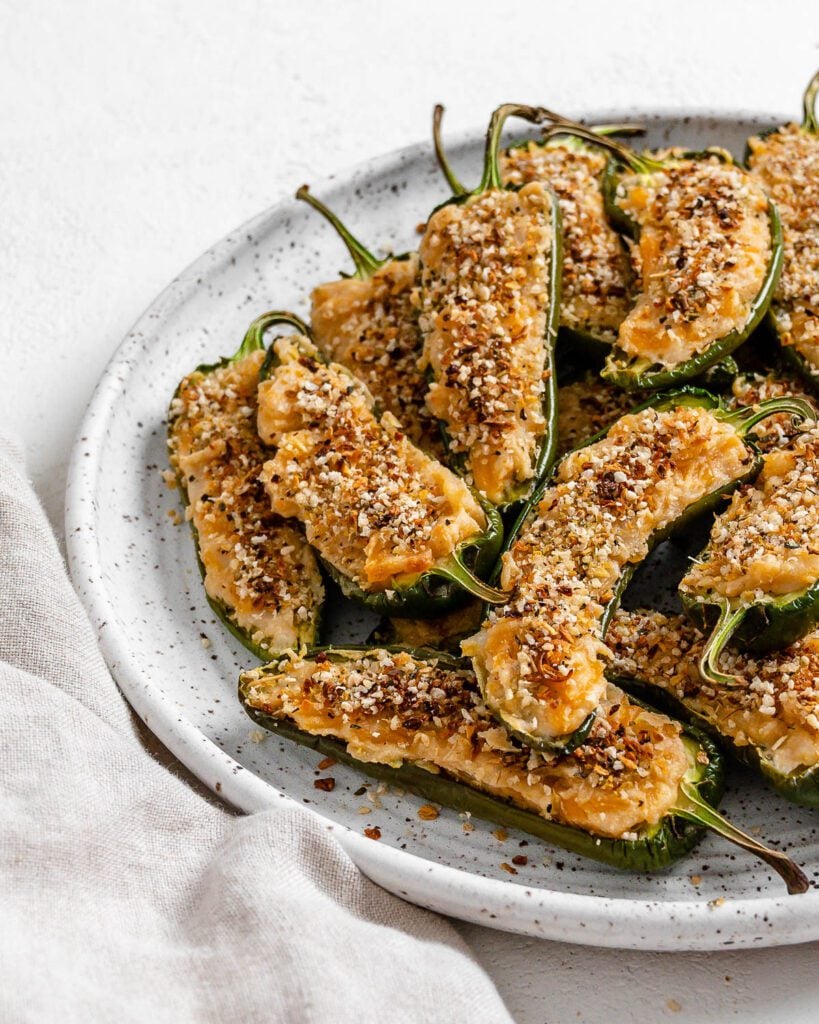 completed Vegan Jalapeno Poppers on a white speckled plate against a white background