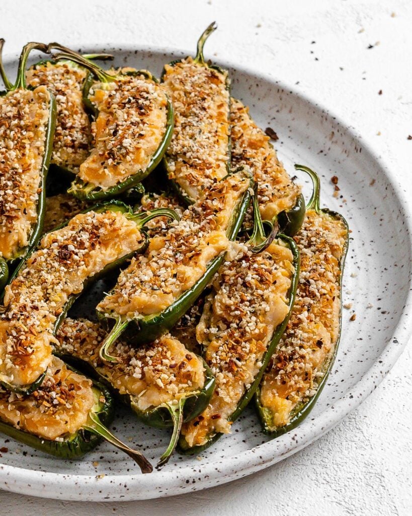 completed Vegan Jalapeno Poppers on a white speckled plate against a white background