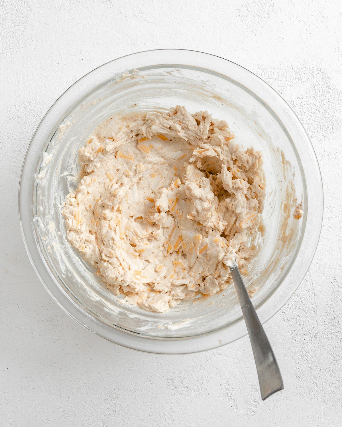 flour mixture in a clear glass bowl against a white surface