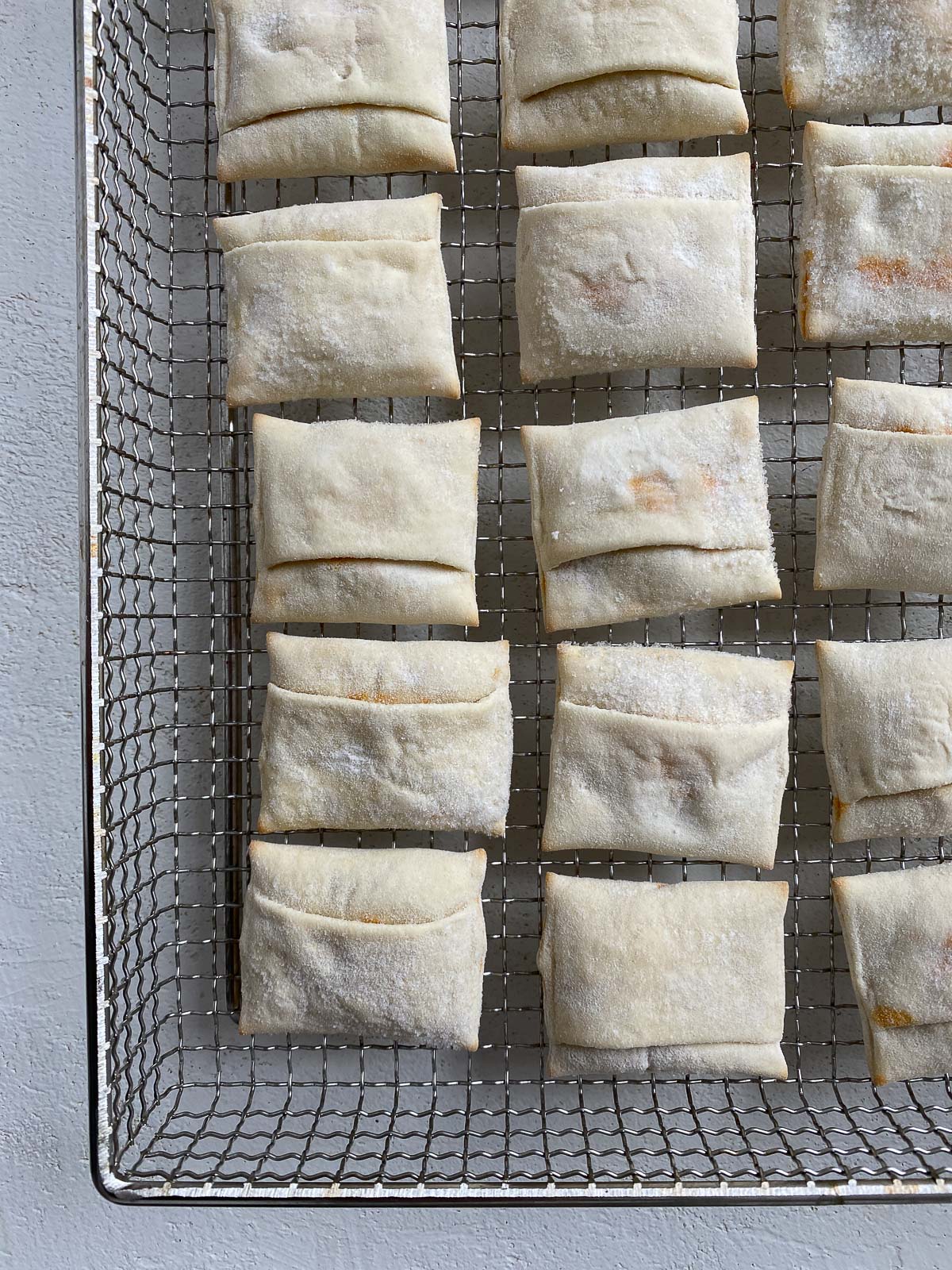 uncooked pizza rolls on an air fryer tray