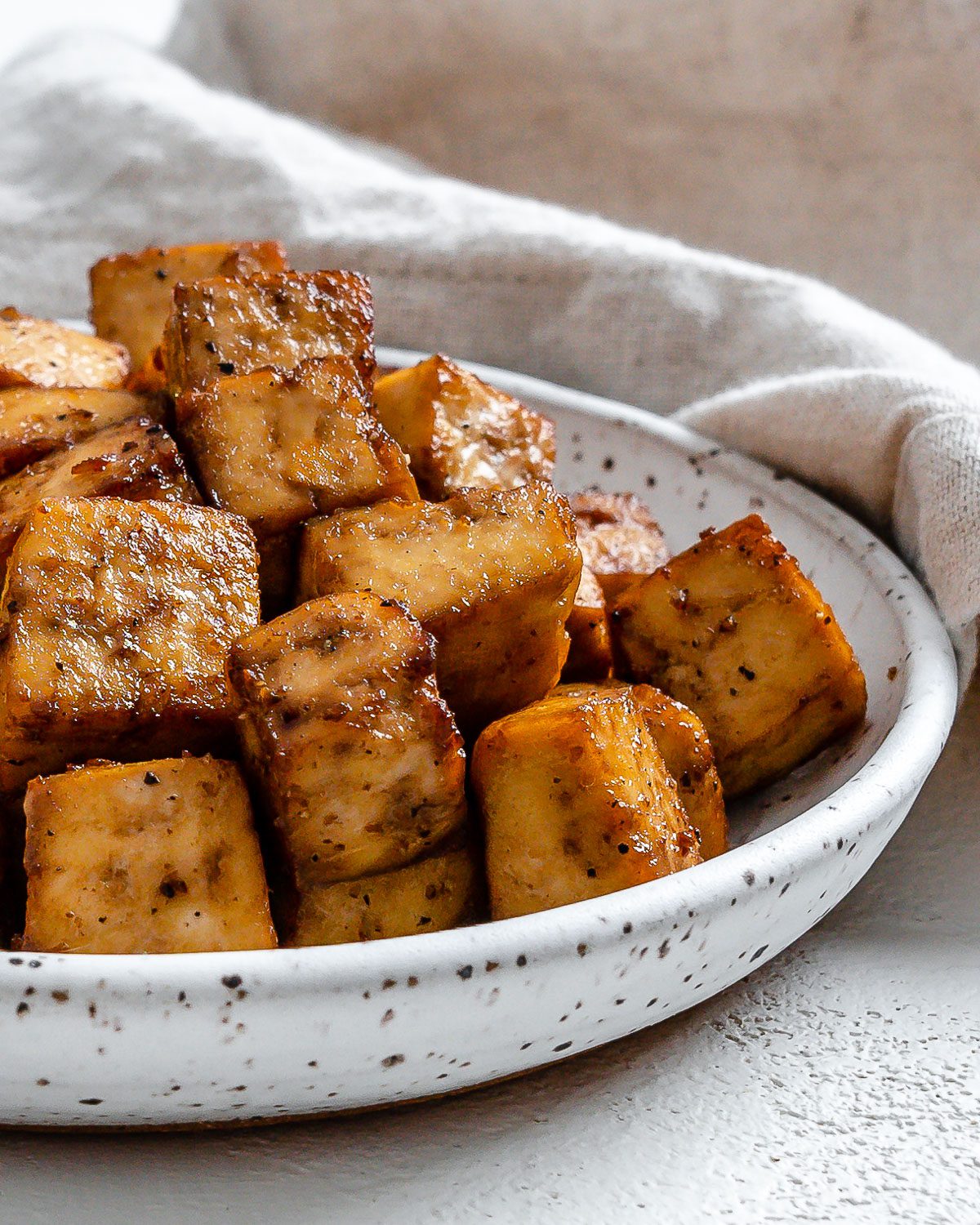 Completed Air Fryer Tofu plated against a light surface.