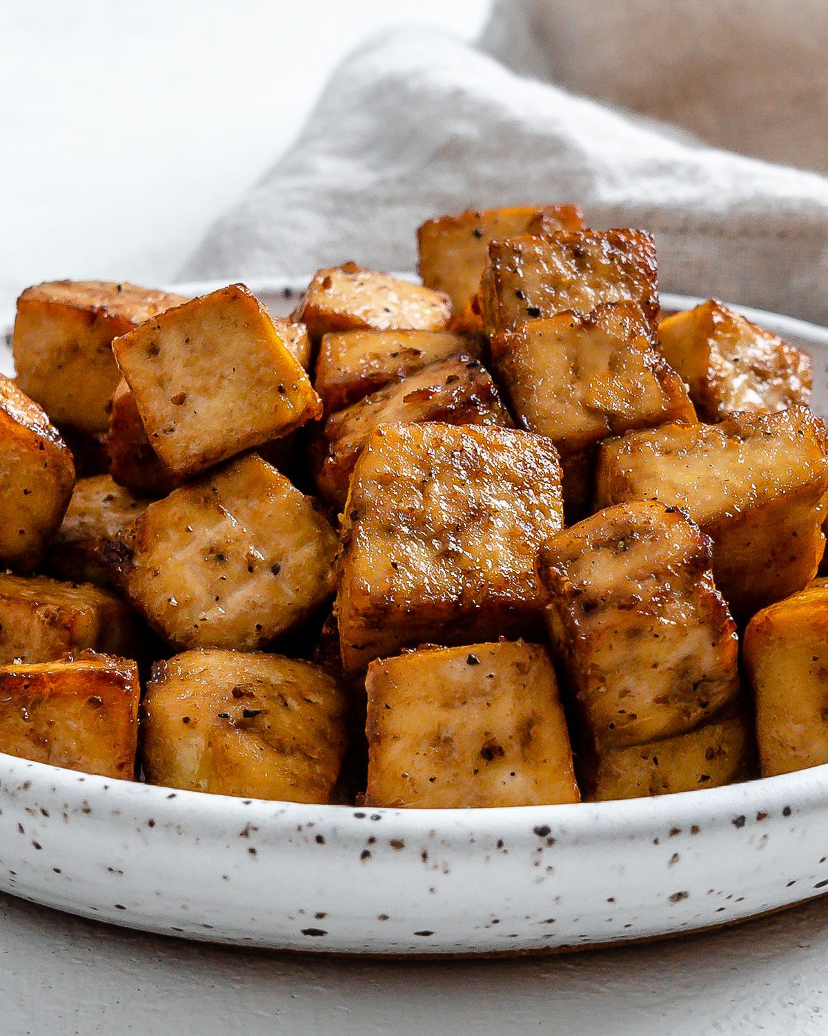 Completed Air Fryer Tofu plated against a light surface.