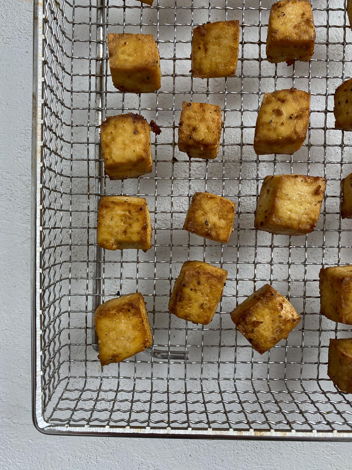 Post cooked tofu on an air fryer tray.
