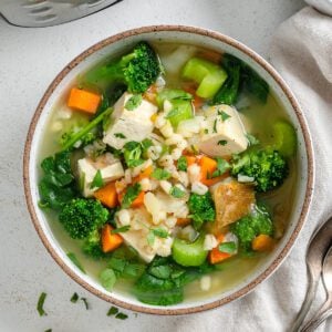 completed Instant Pot Vegetable Barley Soup in a white bowl against a white background