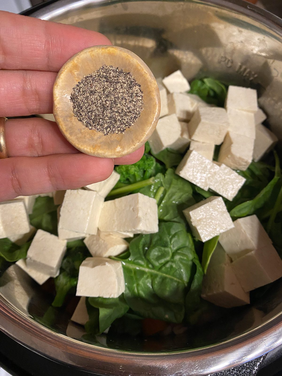 process shot of salt and pepper being added to instant pot