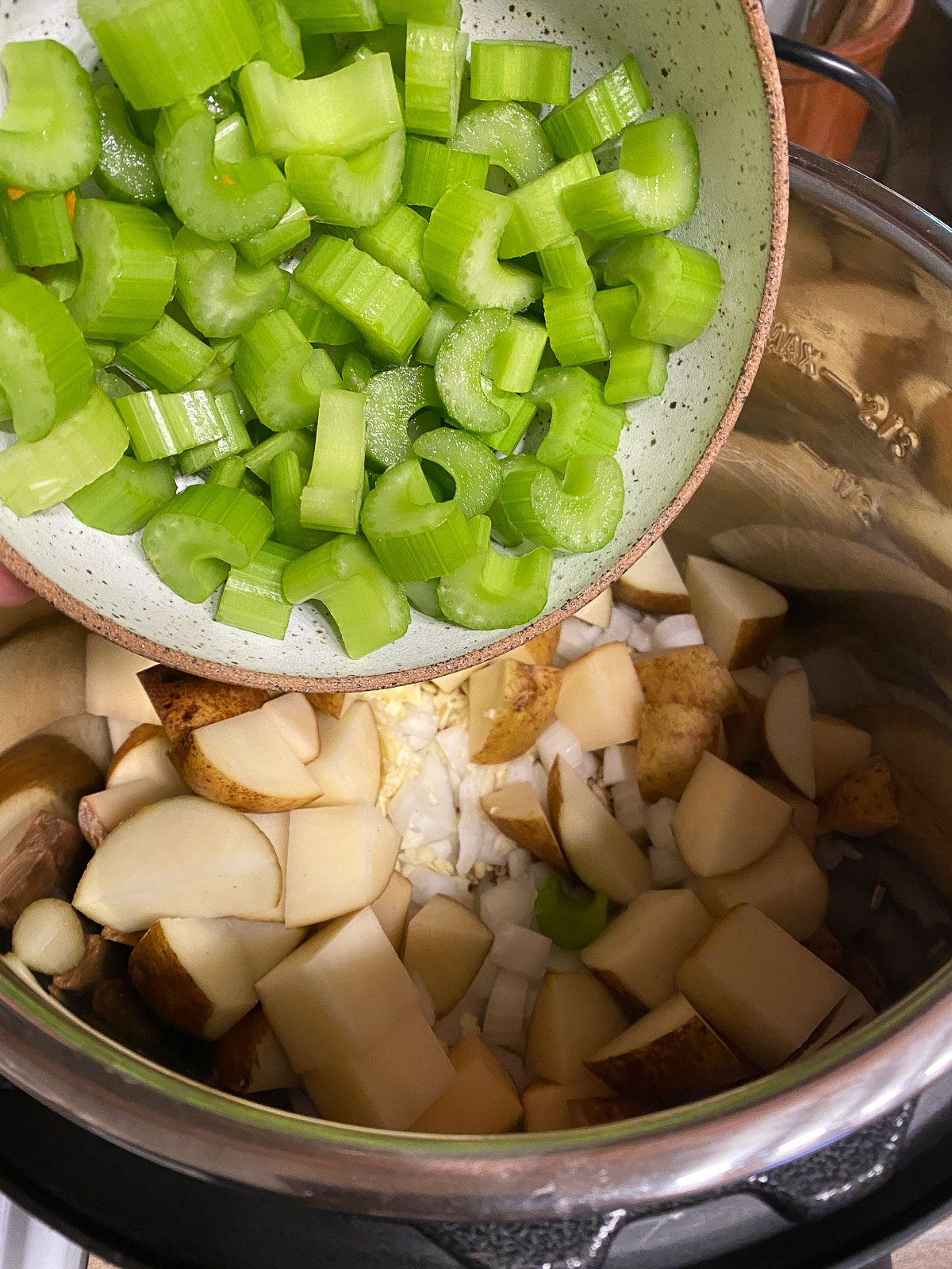 process shot of celery being added to instant pot