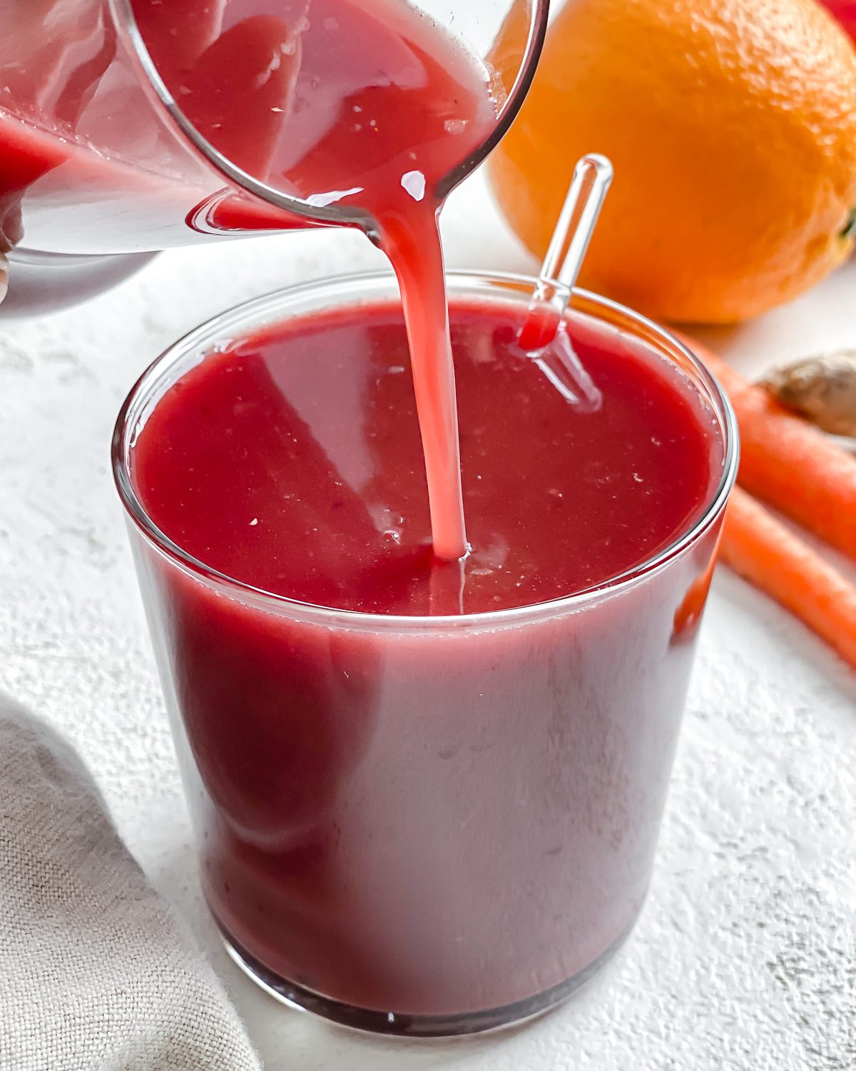 process shot of juice being poured into a glass