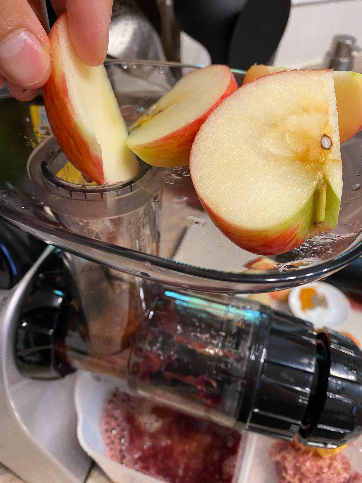 process shot of putting apple into juicer