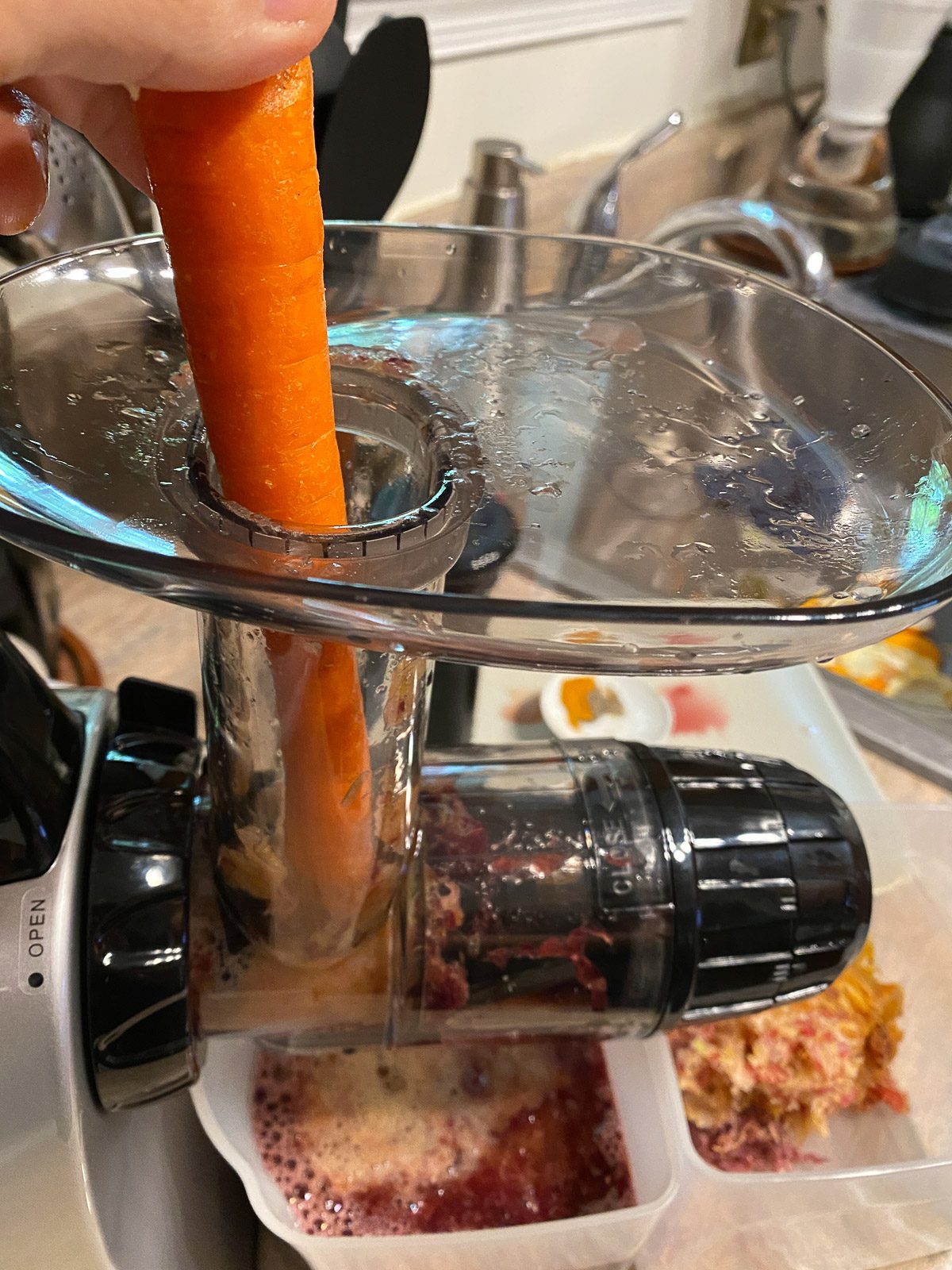 process shot of adding carrot to juicer