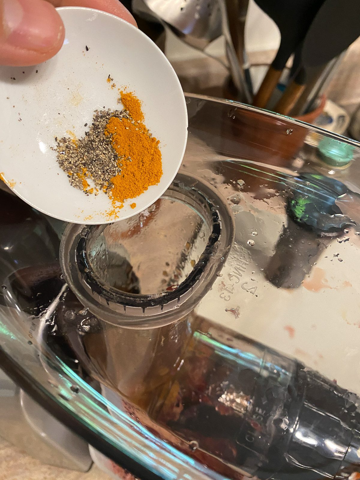 process shot of adding spices to juicer