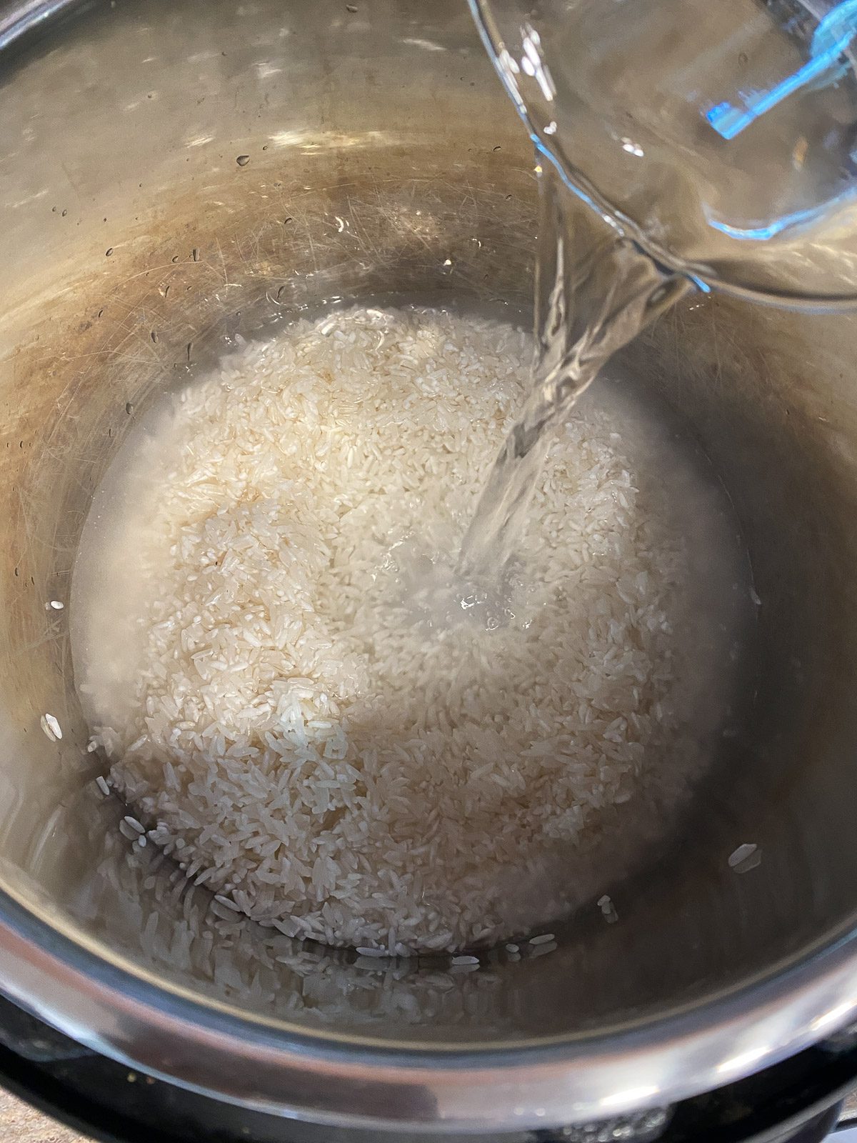 process shot of water being added to rice in pot