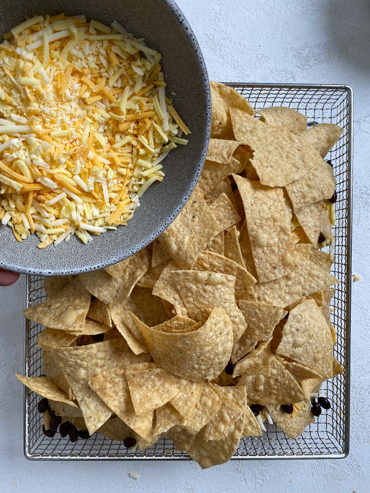 process shot of adding vegan cheese to air fryer rack