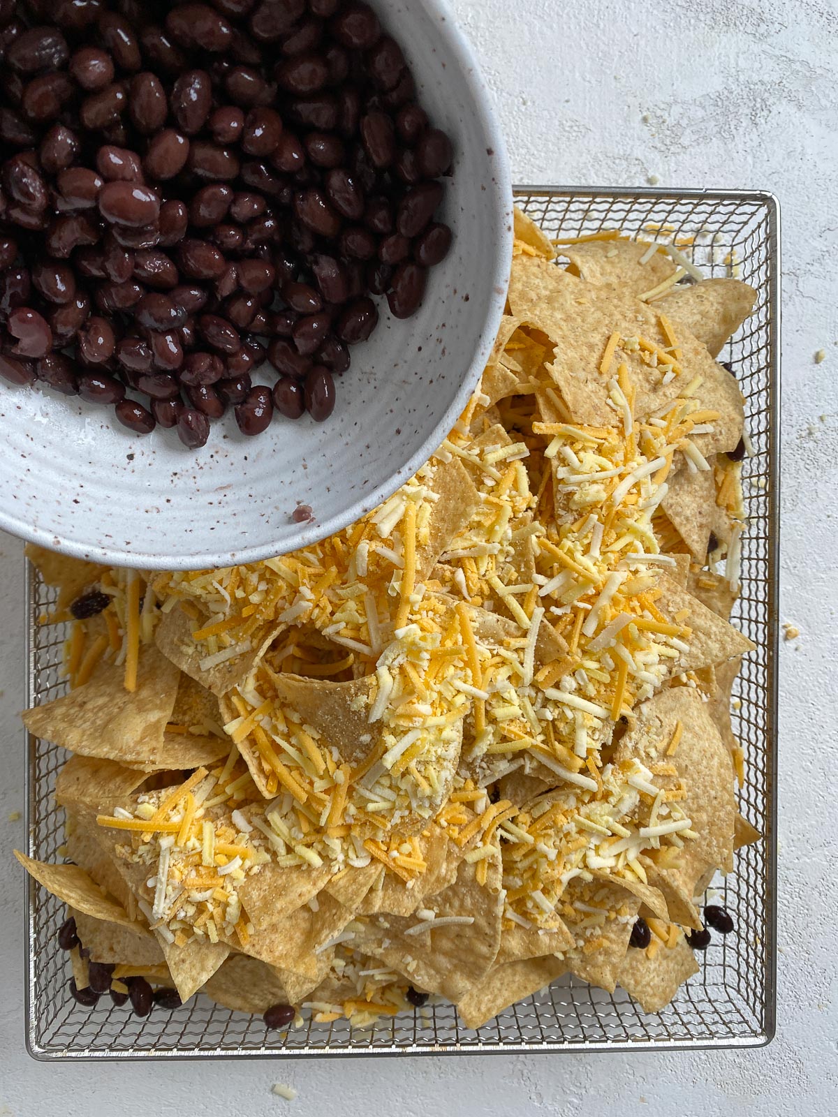 process shot of adding beans to air fryer rack