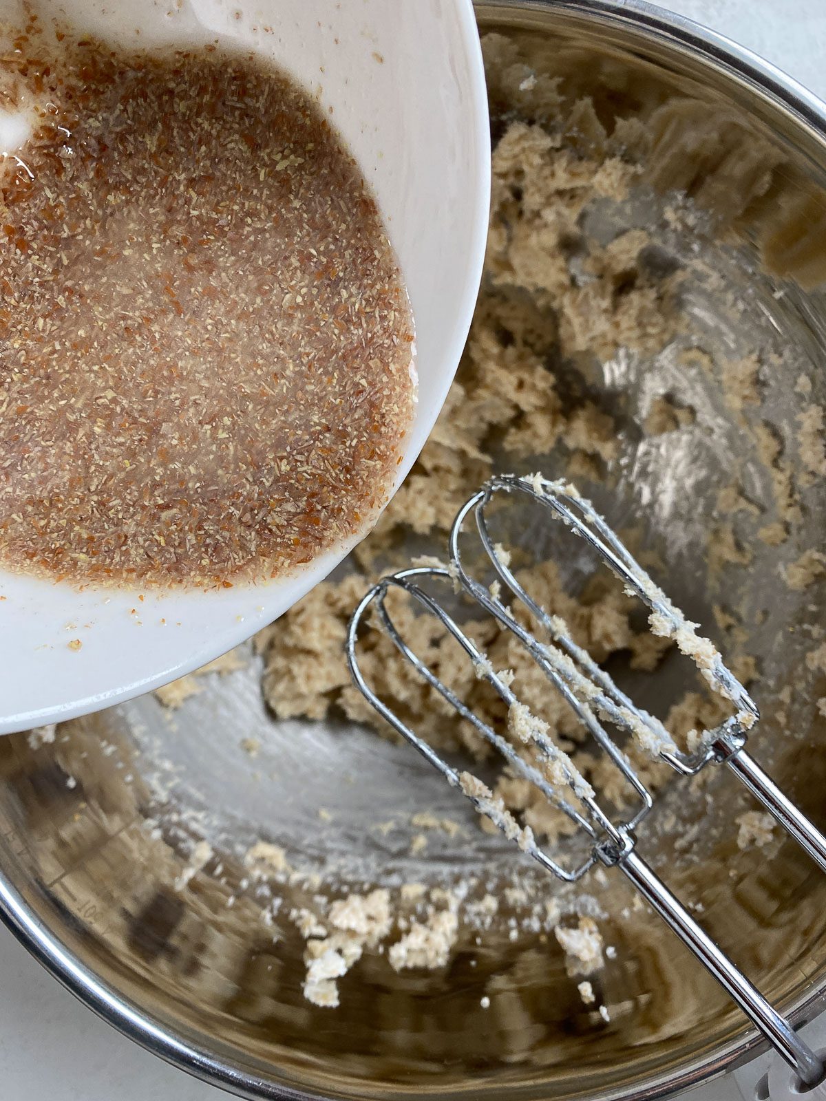 process of adding flaxseed mixture into mixer bowl