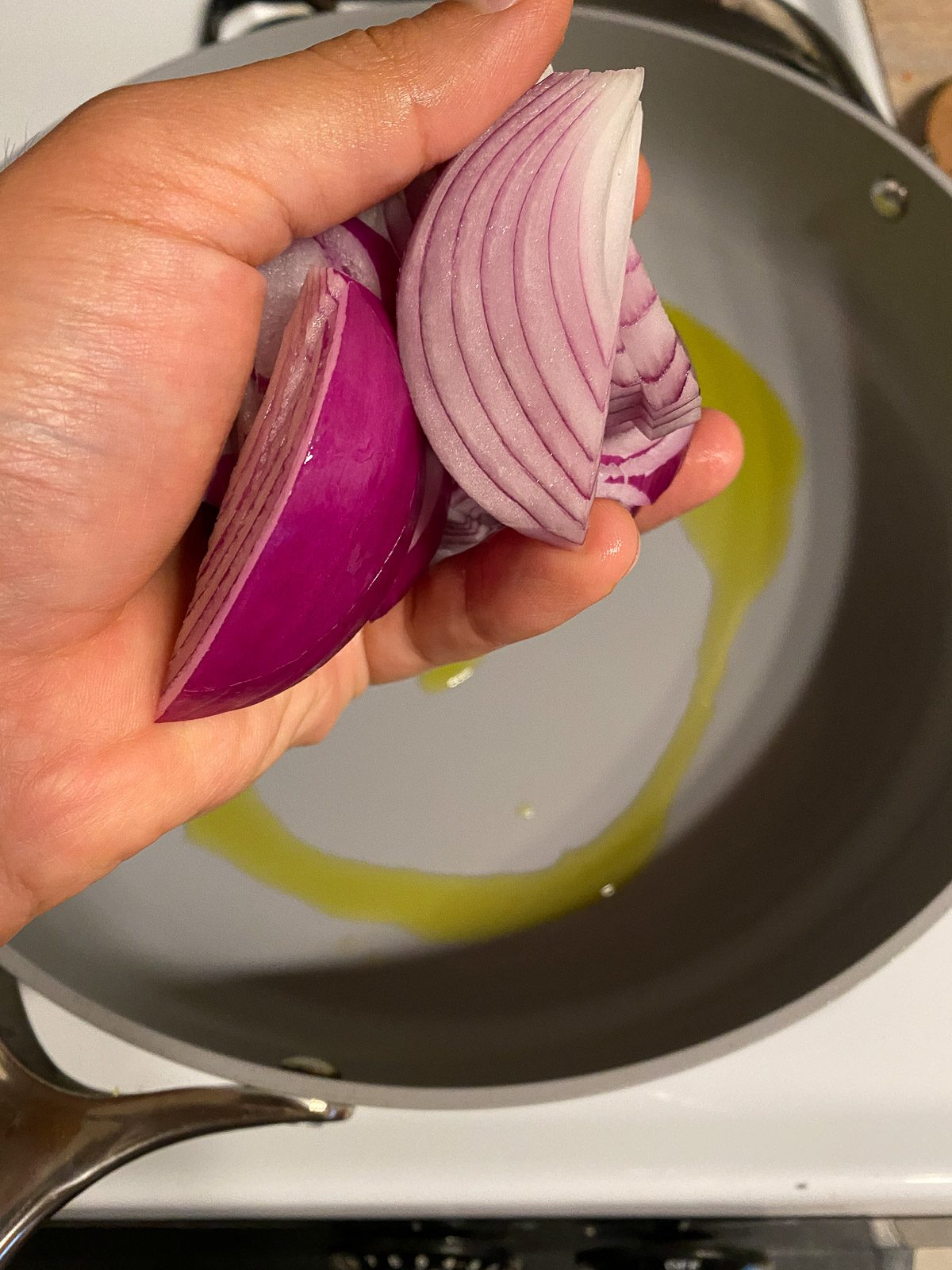 process of adding onions to skillet