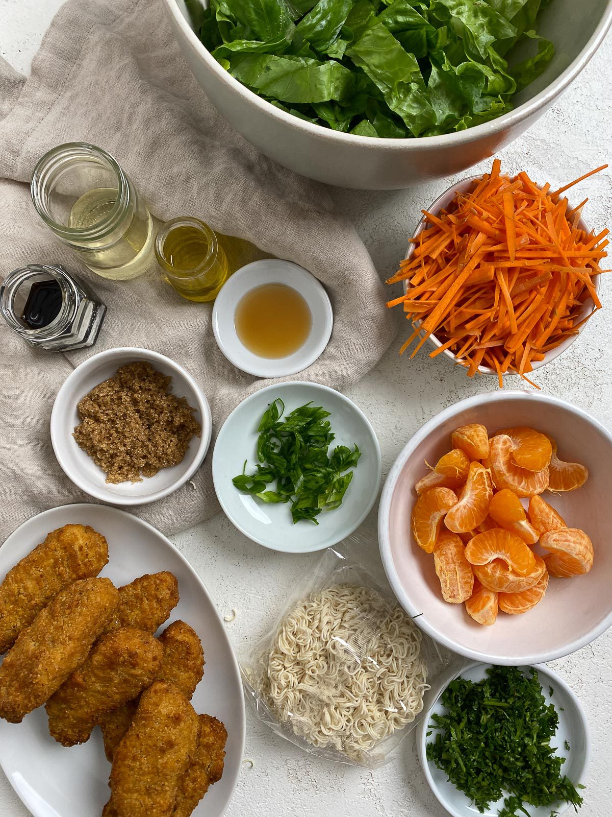ingredients for Vegan Asian Mandarin Chicken Ramen Noodle Salad measured out against a light surface
