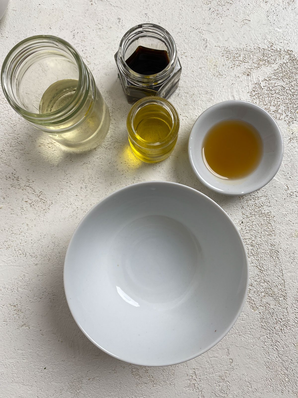 ingredients for Vegan Asian Mandarin Chicken Ramen Noodle Salad alongside white bowl measured out against a light surface