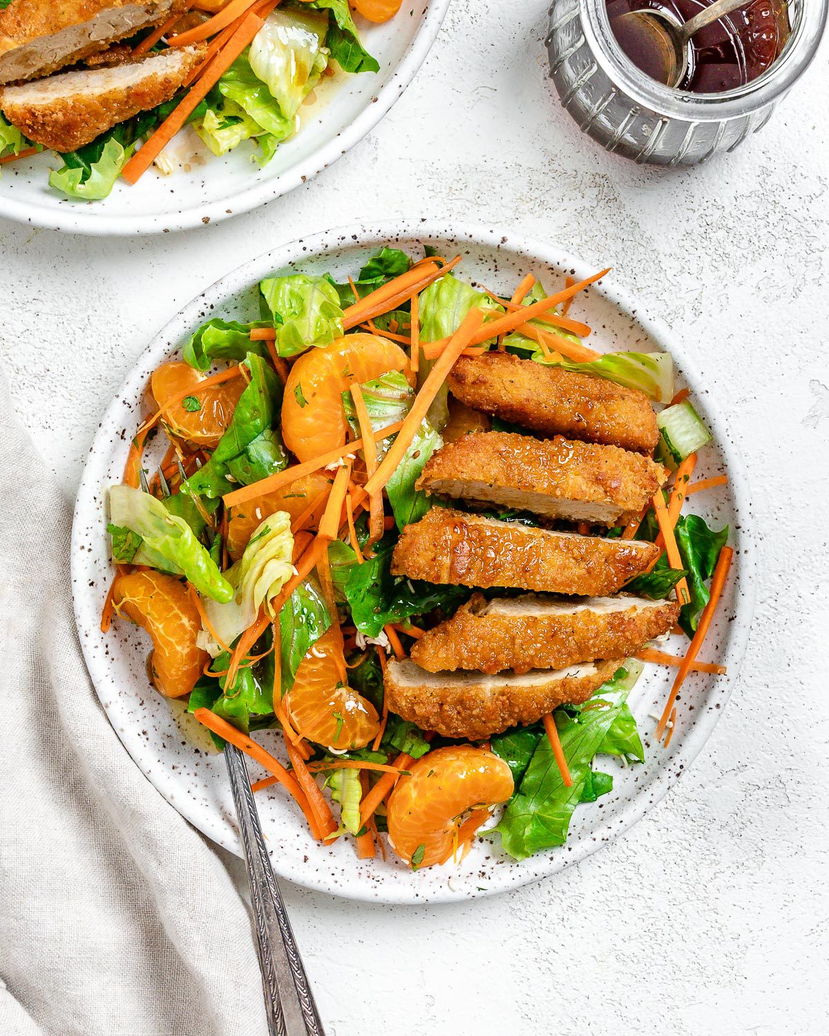 completed Vegan Asian Mandarin Chicken Ramen Noodle Salad on a white plate against a white background