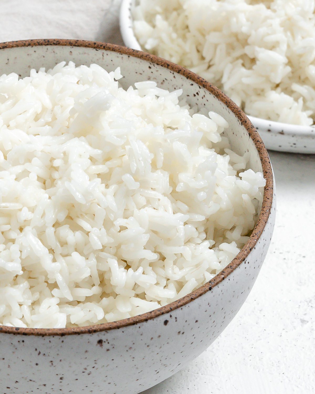 completed Instant Pot Basmati Rice in a white bowl against a light background
