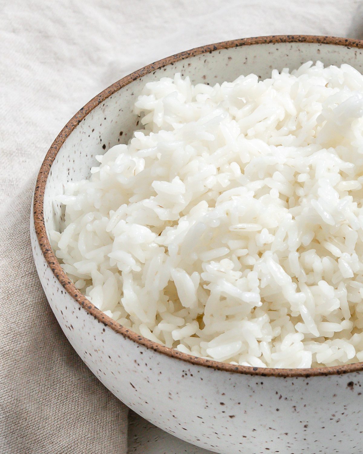 completed Instant Pot Basmati Rice in a white bowl against a light background