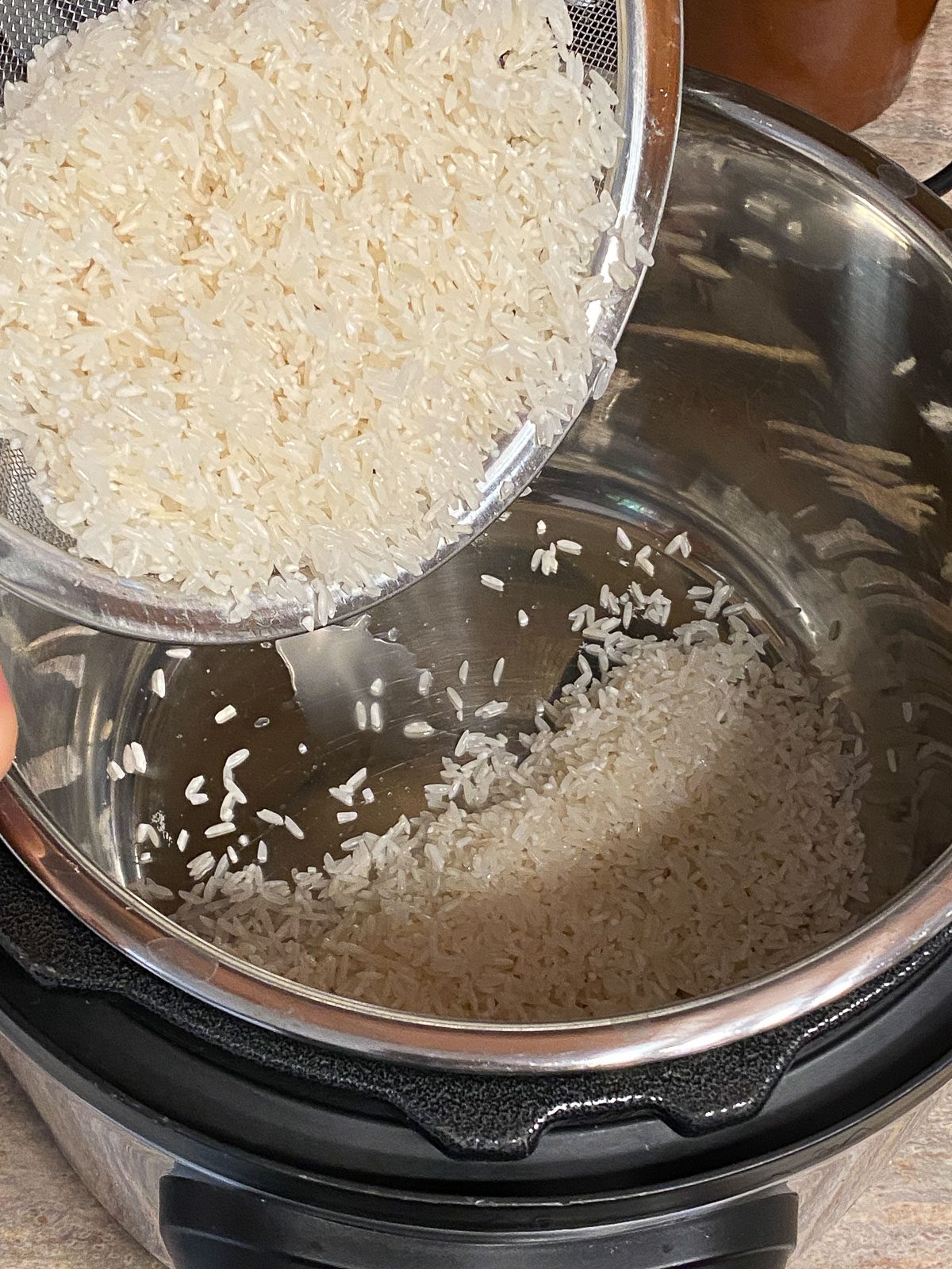 process shot of adding rice to instant pot