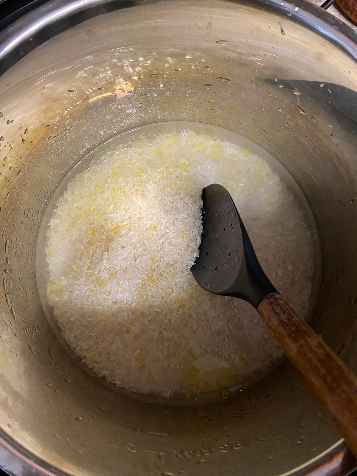 process shot of mixing instant pot basmati rice ingredients in instant pot