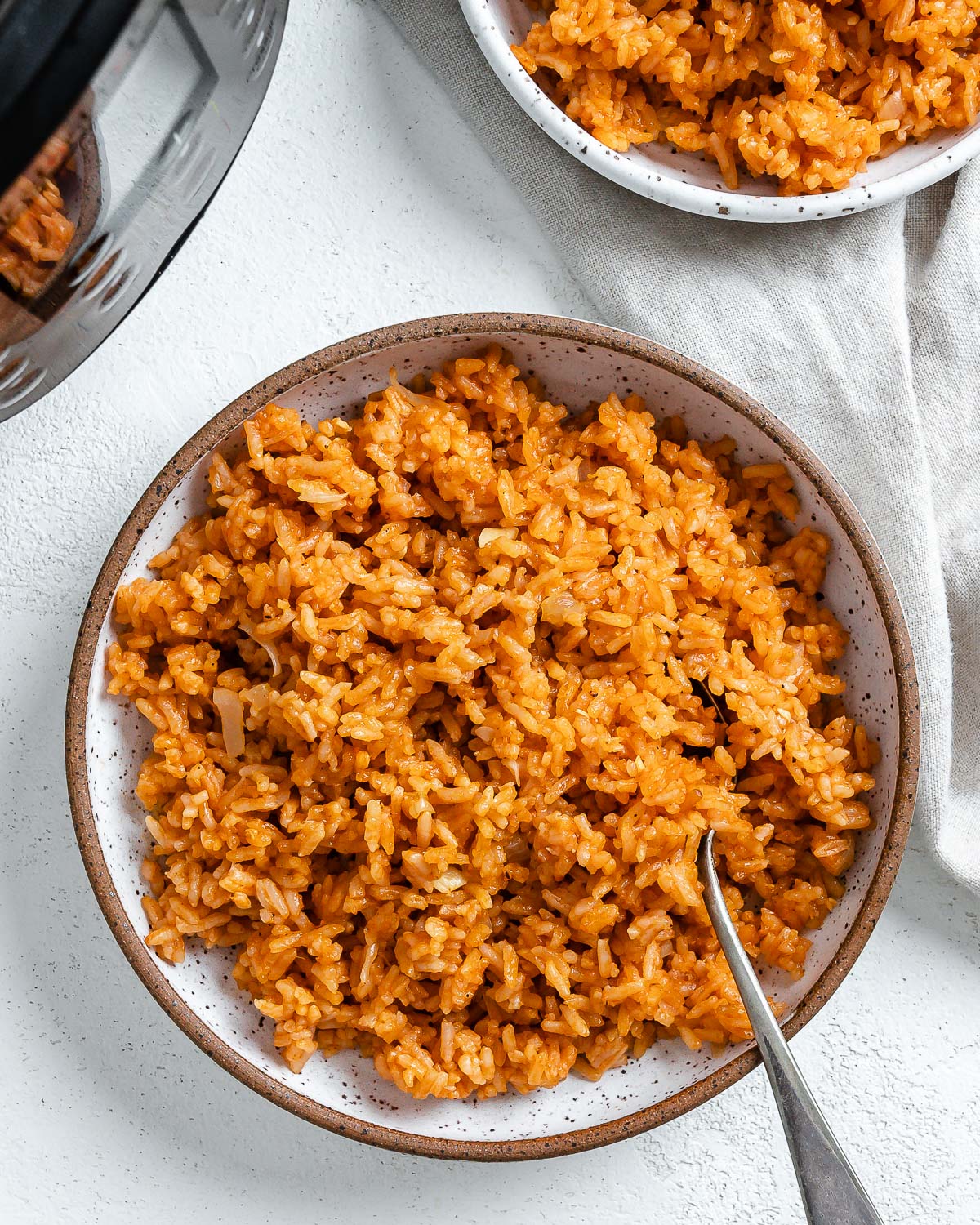 completed mexican rice in a white bowl against a white background