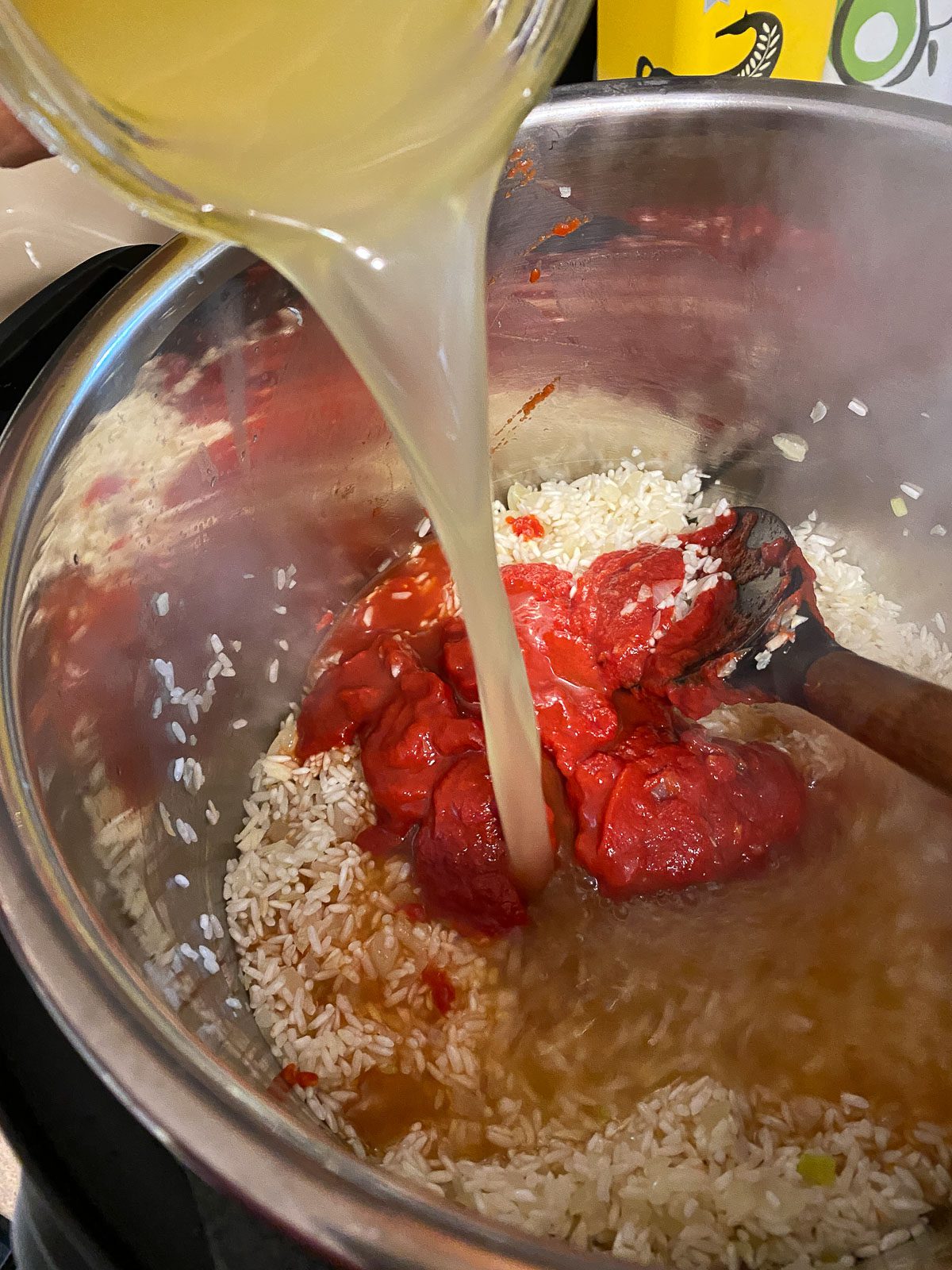 process of adding broth to pot