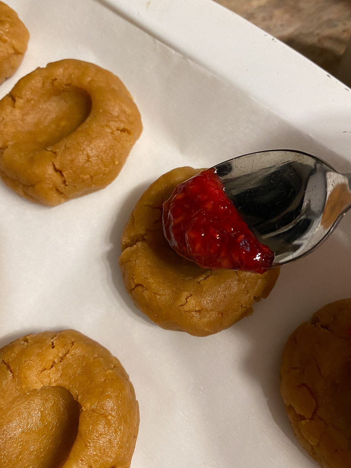 process of adding filling to indent of cookie dough
