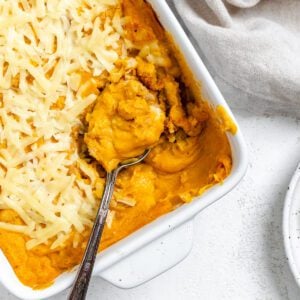 completed Vegan Buffalo Chicken Dip in a baking dish against a light background