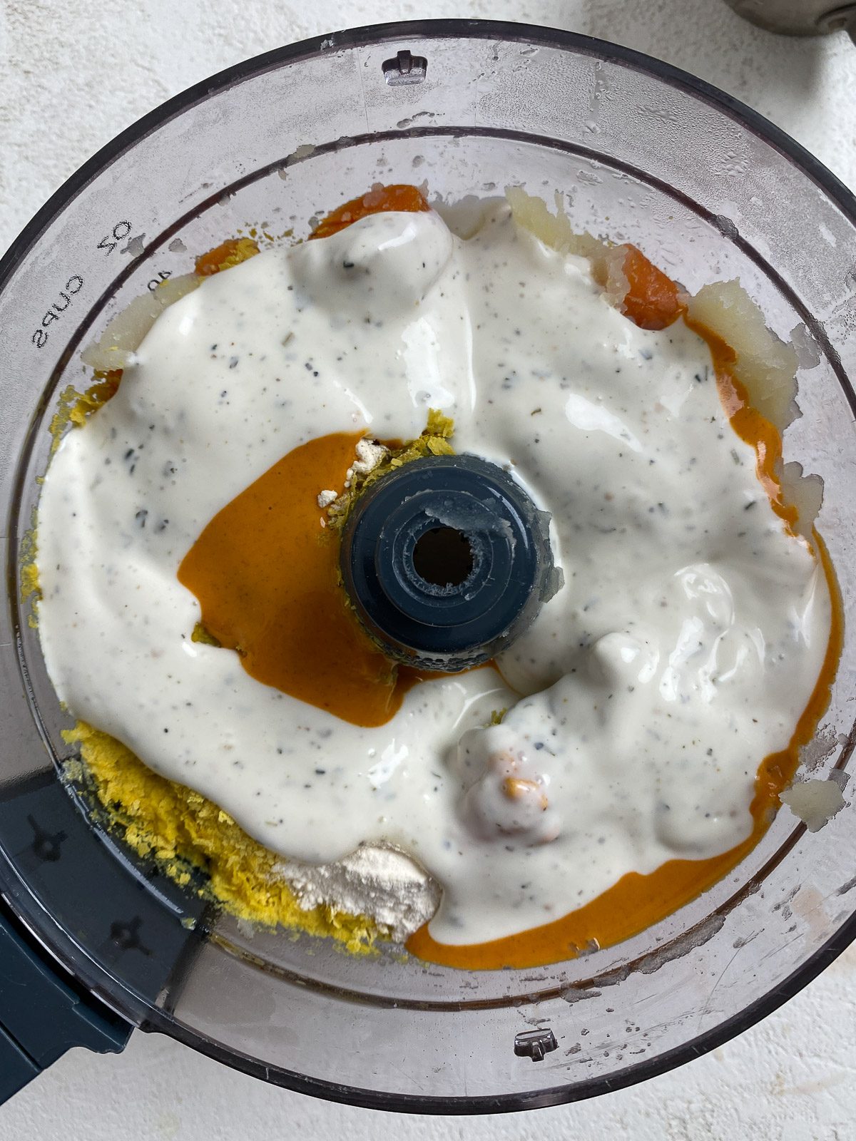 the addition of Vegan Buffalo Chicken Dip ingredients into blender