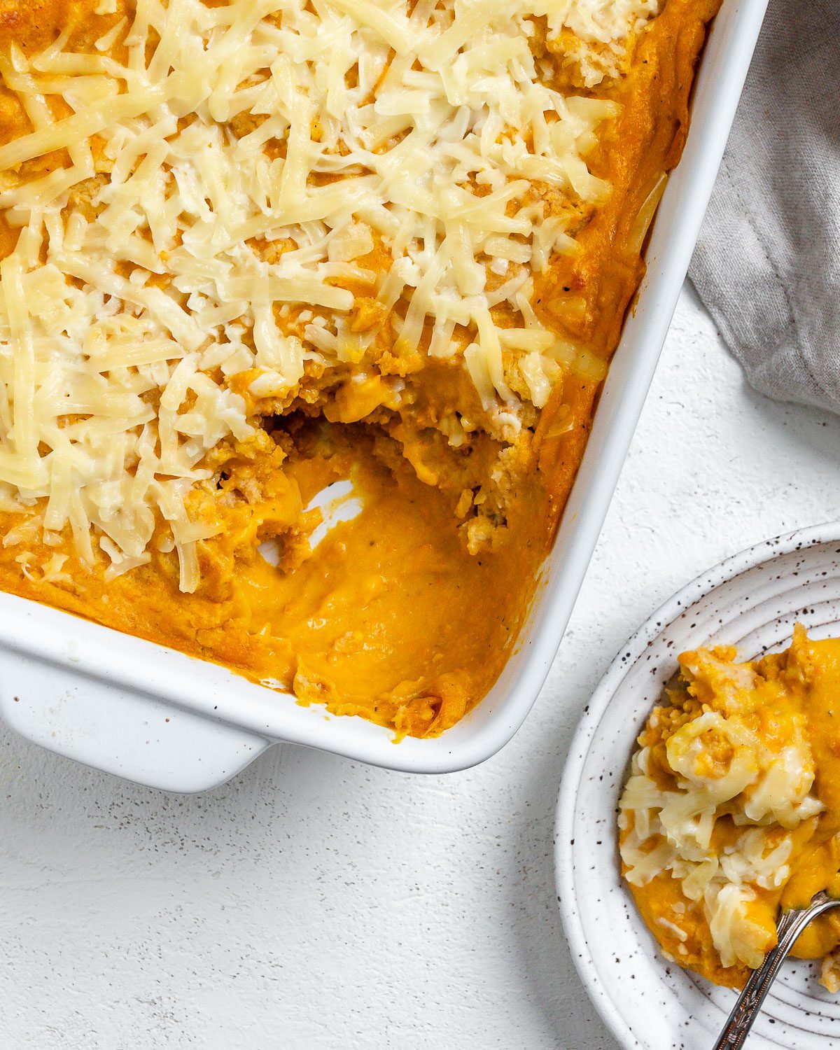 completed Vegan Buffalo Chicken Dip in a baking dish against a light background