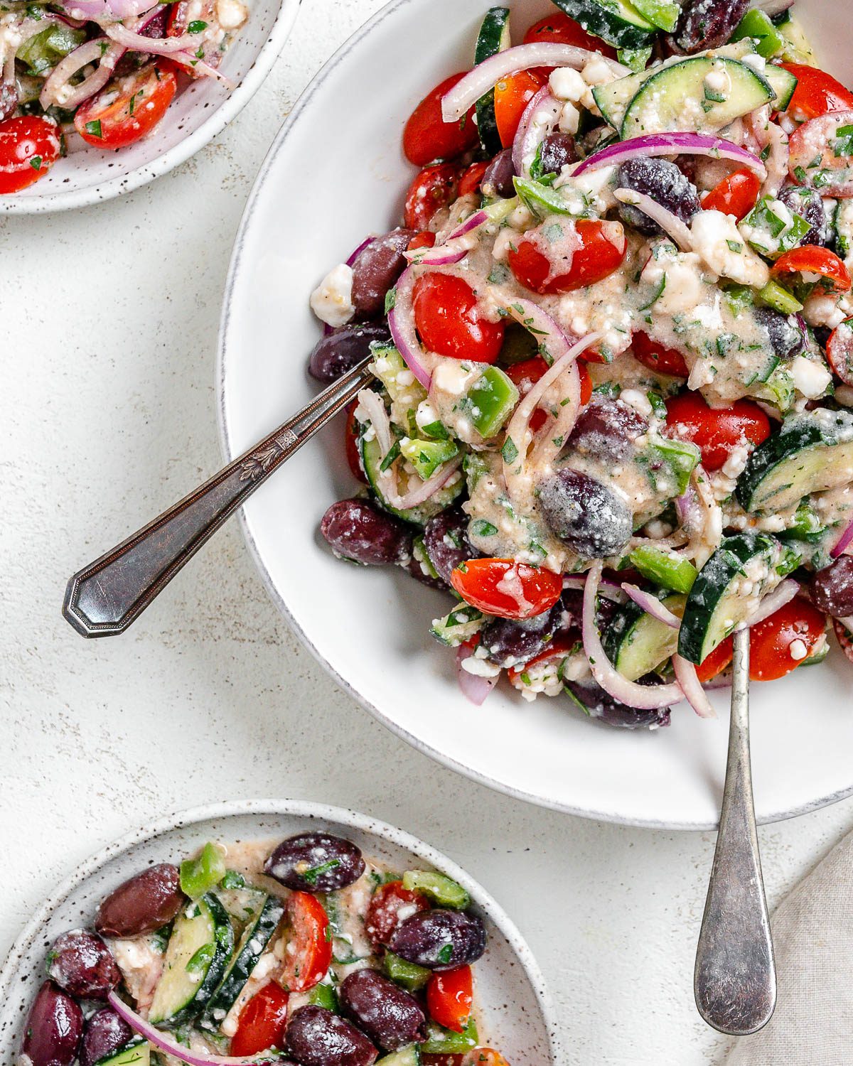 completed Vegan Greek Salad on a white plate against a white background