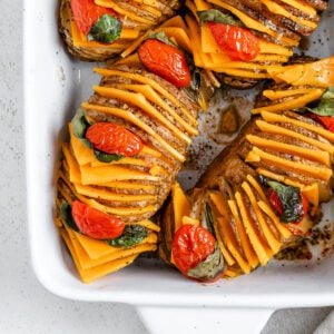 completed Vegan Hassleback Potatoes in a white backing dish