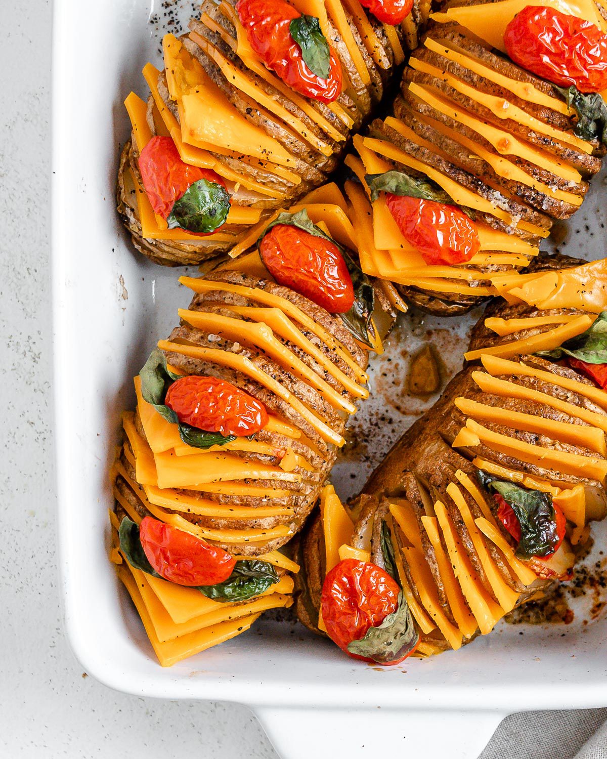completed Vegan Hassleback Potatoes in a white backing dish