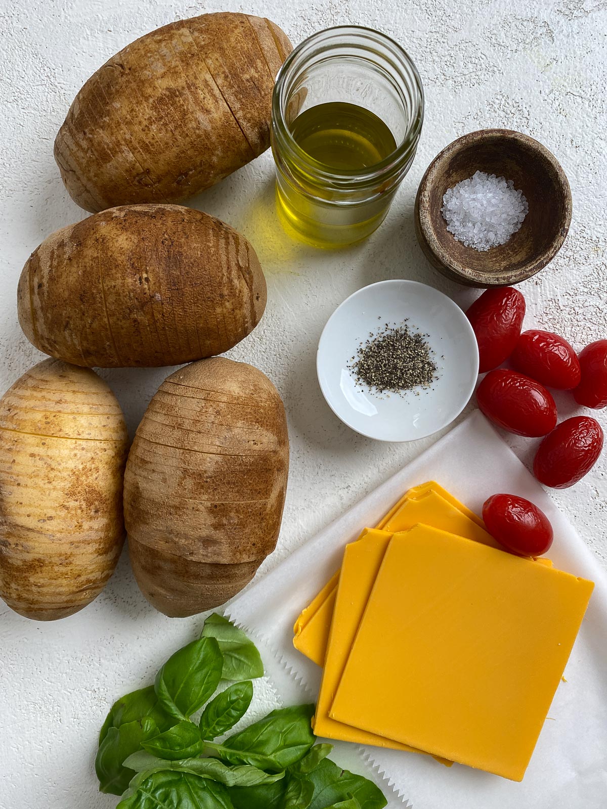 ingredients for Vegan Hassleback Potatoes on a white surface
