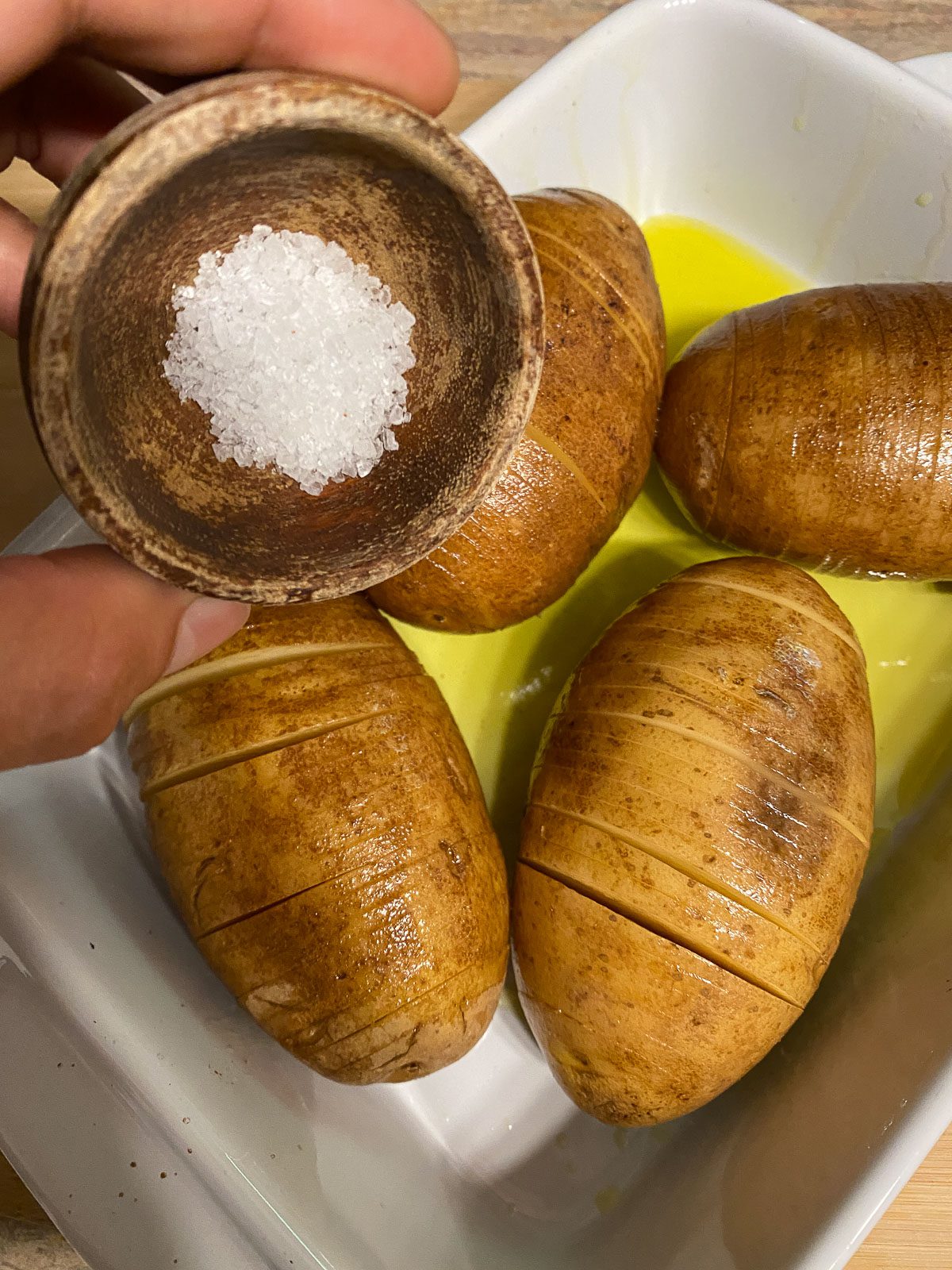 process of pouring salt onto potatoes
