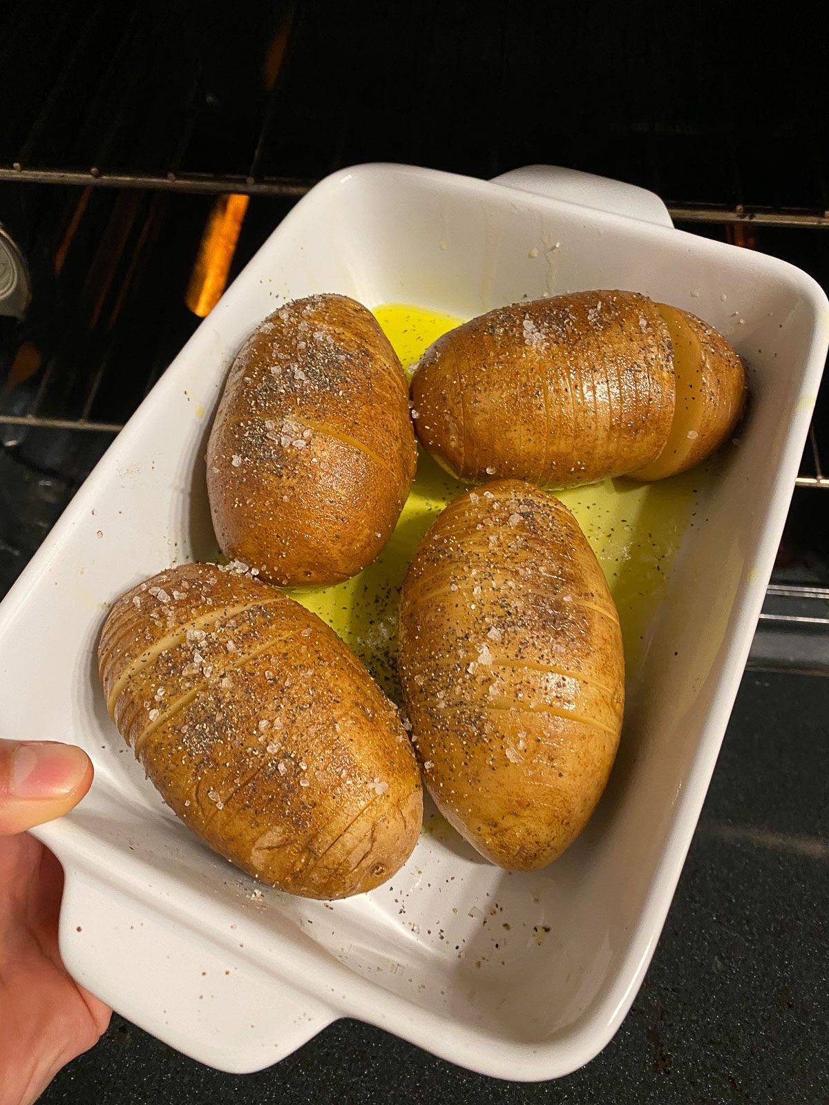 process of placing potatoes into oven