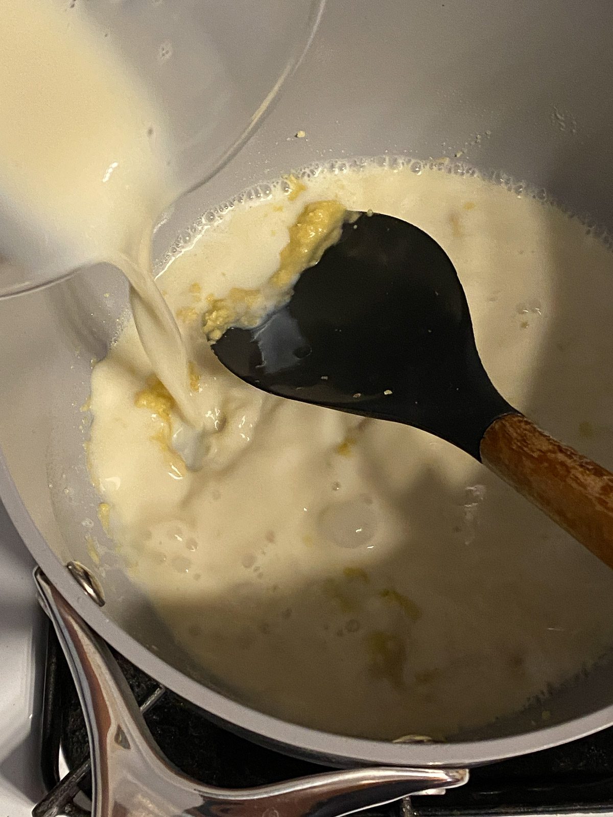 proces of plant based milk being added to cheese mixture