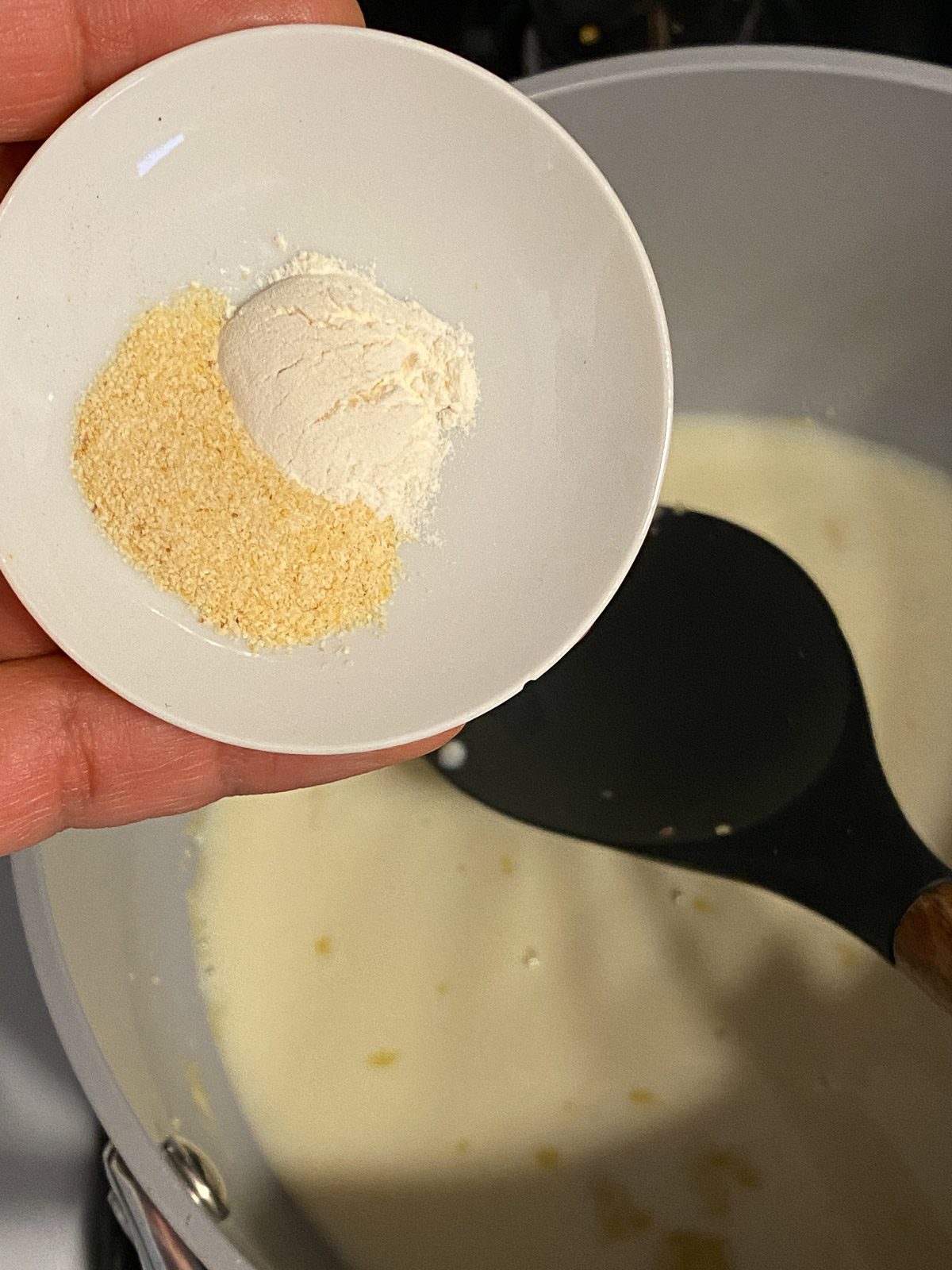 process of seasonings being added to cheese sauce