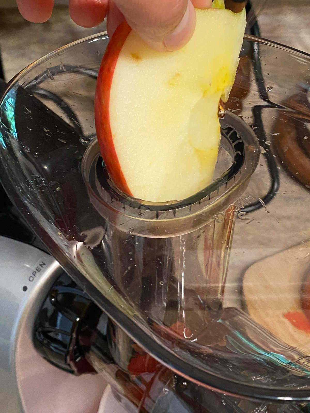 process shot adding apple to juicer