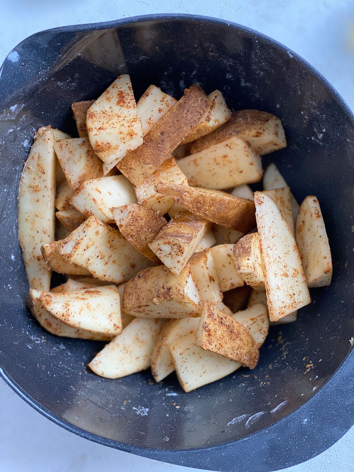 post mixing spices and potato wedges in air fryer
