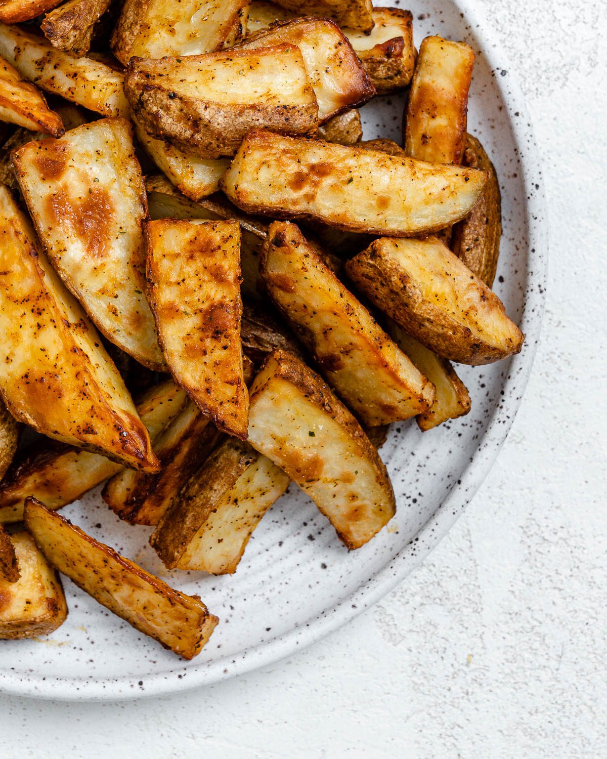 completed Air Fryer Potato Wedges plated on a white plate
