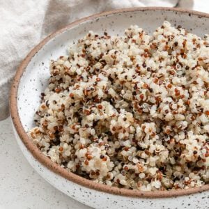 completed Pressure Cooker Quinoa in a white bowl against a white background